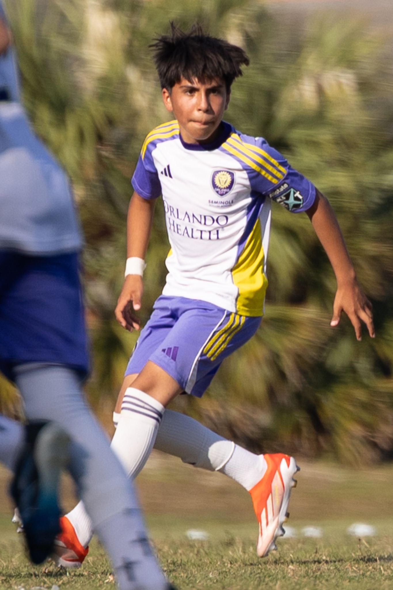 Youth soccer player running with ball in action — sports action photography Volusia County FL — Heidi Lynne Photography