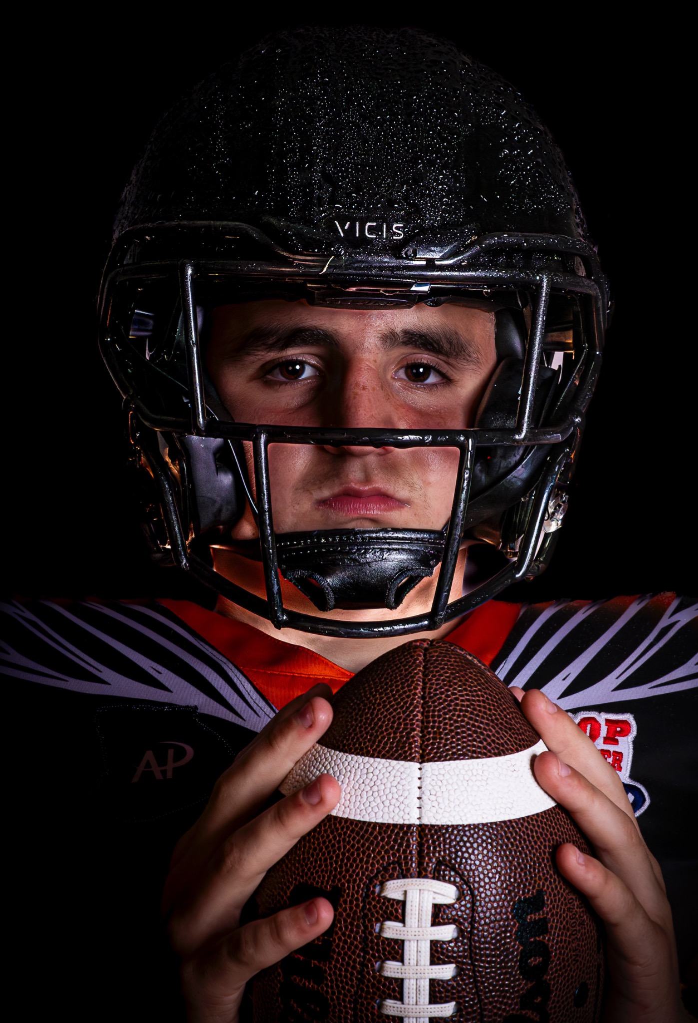 Football player action portrait with professional dramatic composition showcasing athletic strength and determination