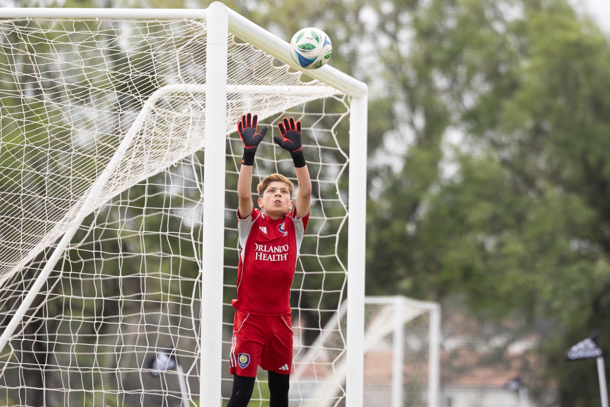 Youth goalkeeper making diving save — soccer action photography Volusia County FL — Heidi Lynne Photography