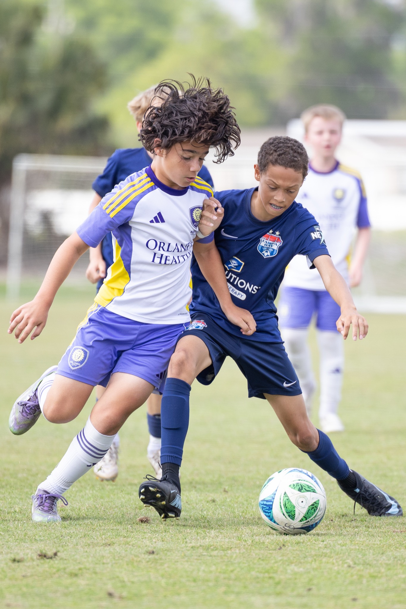 Youth soccer players controlling ball in competitive match — sports action Port Orange FL — Heidi Lynne Photography