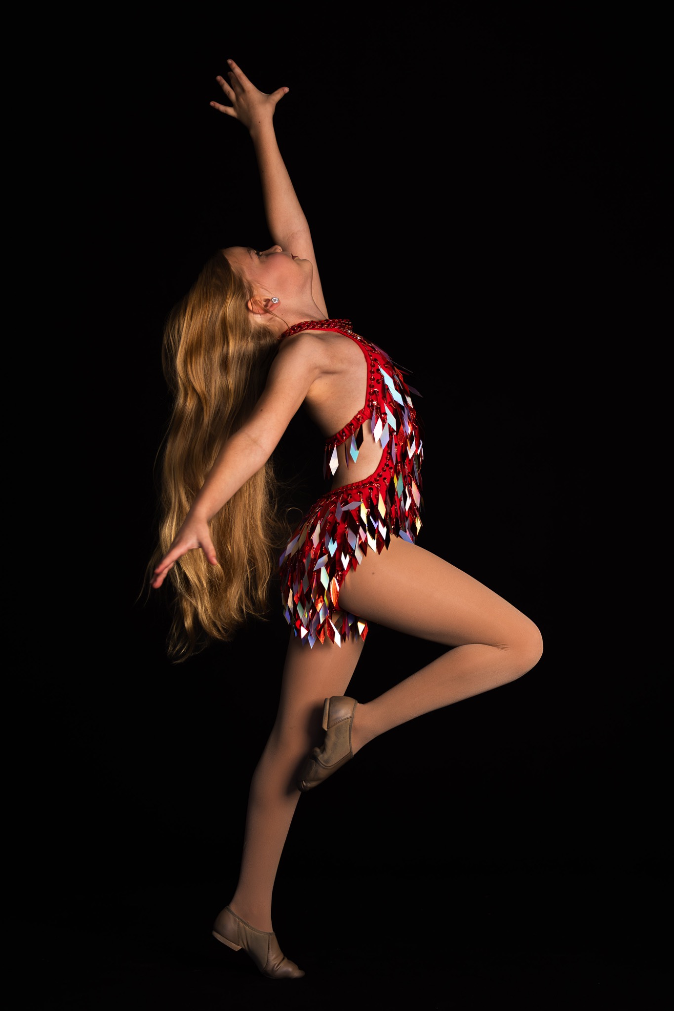 Dancer in action portrait with dramatic lighting and movement capture by professional sports photographer Heidi Lynne